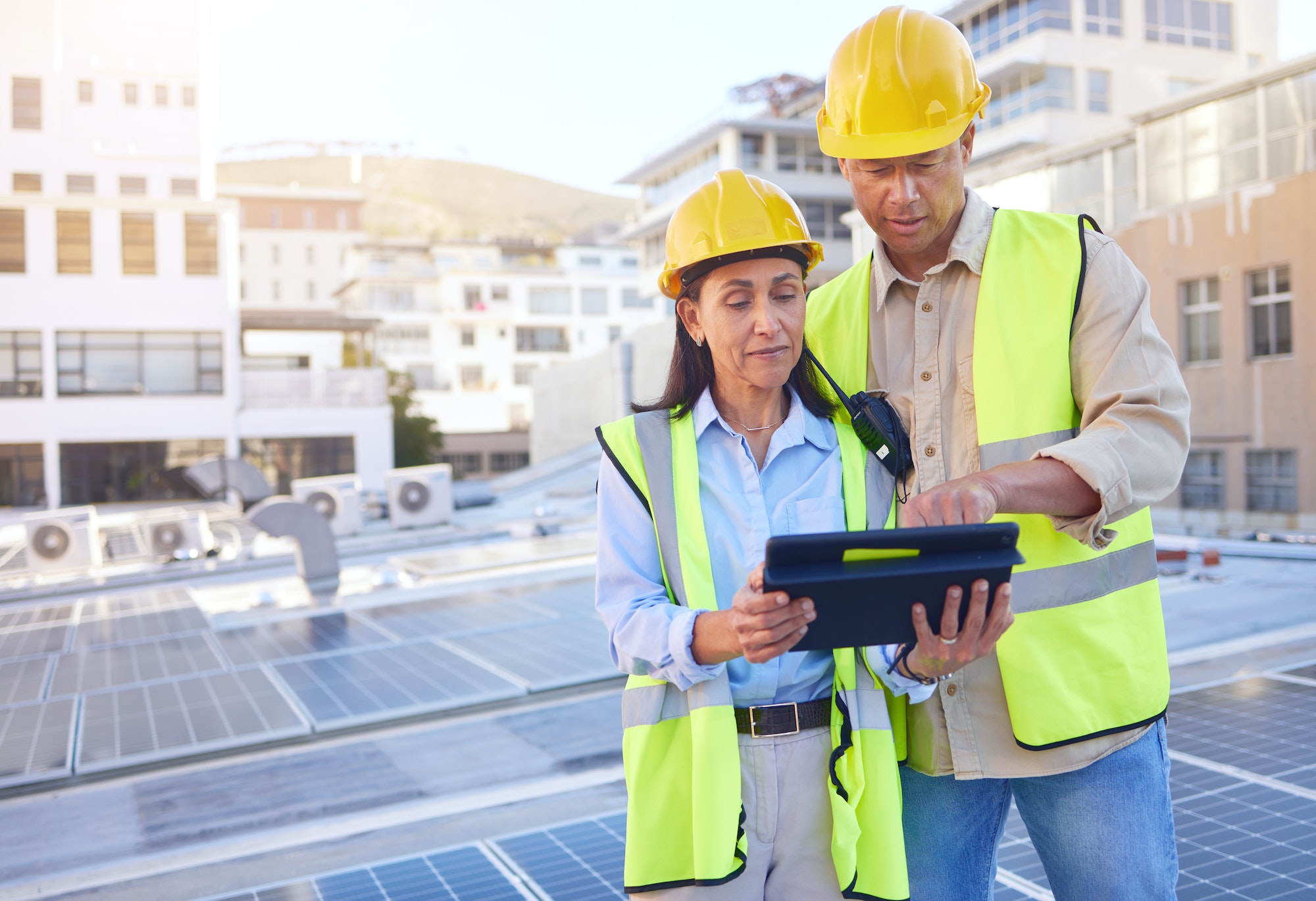 Engineer, man and woman with tablet for online research, schedule for building project and maintena